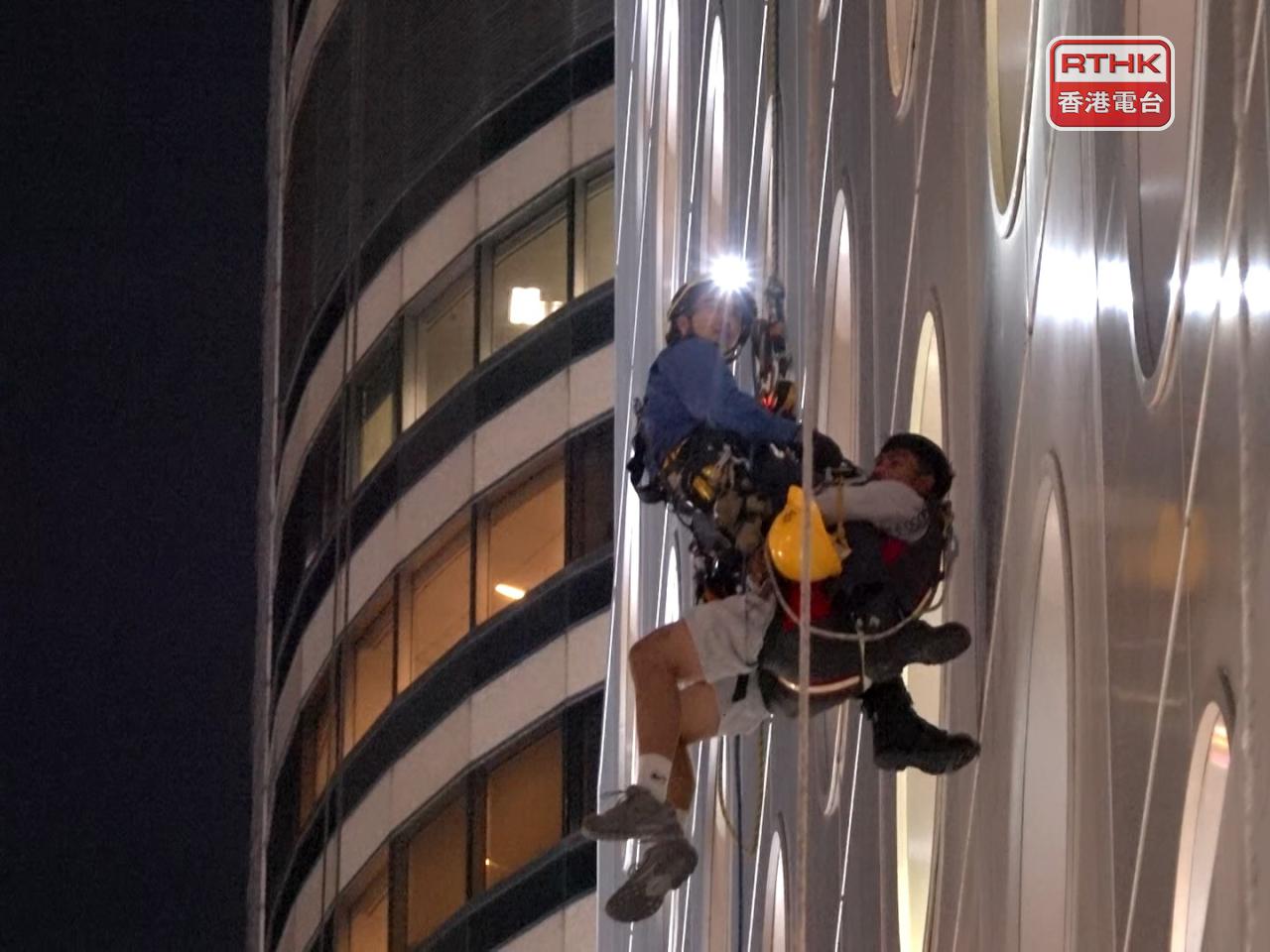 Firefighters abseiled down to rescue the workers. Photo: RTHK