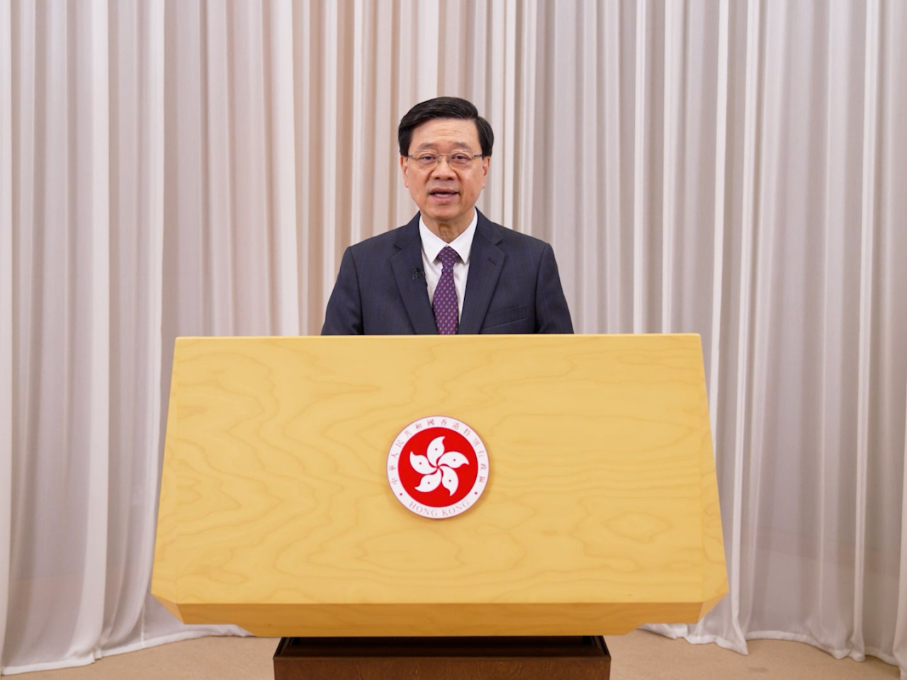 Speaking by video link, John Lee says government leadership will allow the SAR to better tackle climate change. Photo courtesy of Information Services Department